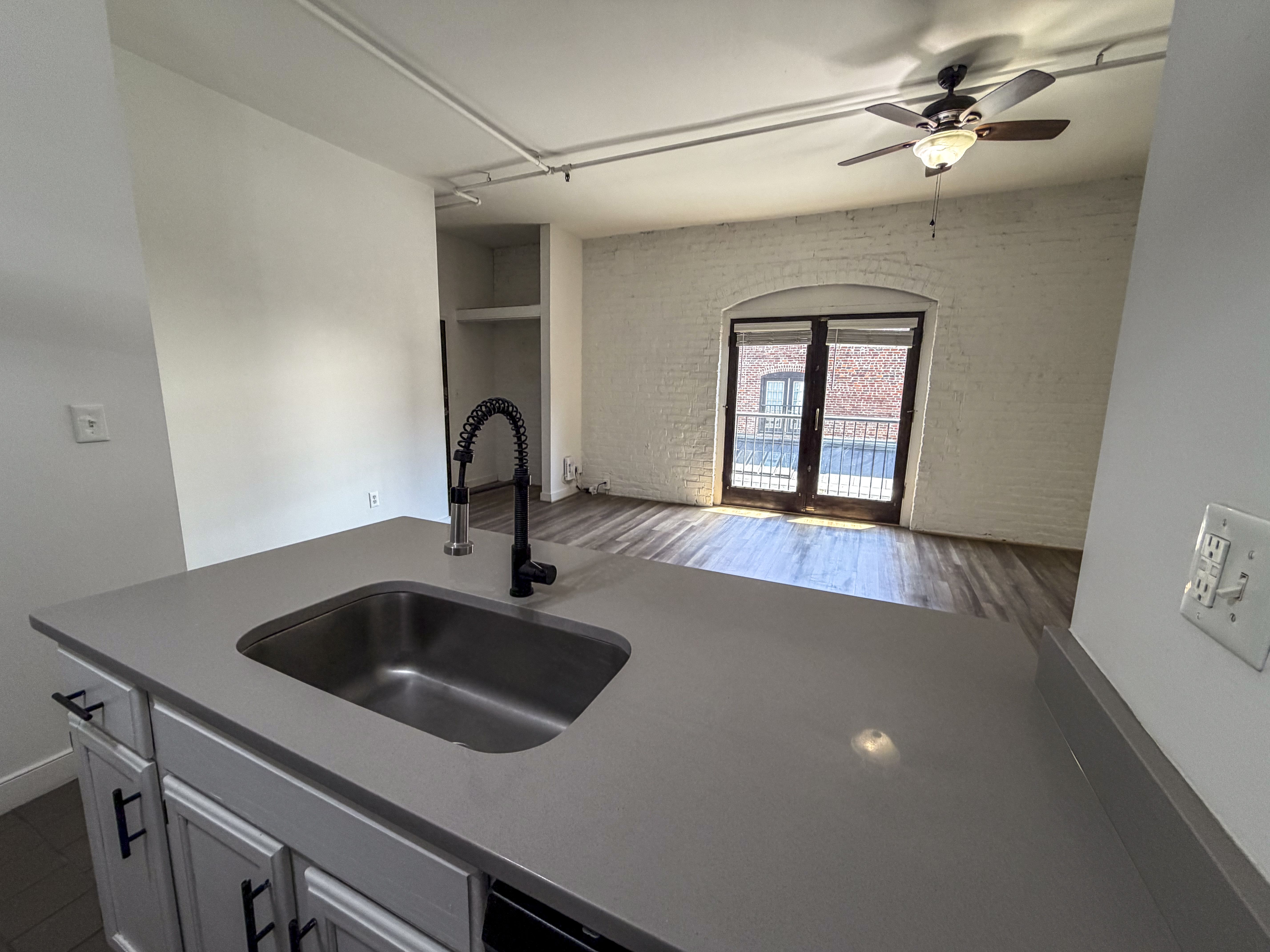 A kitchen with a sink and a window.